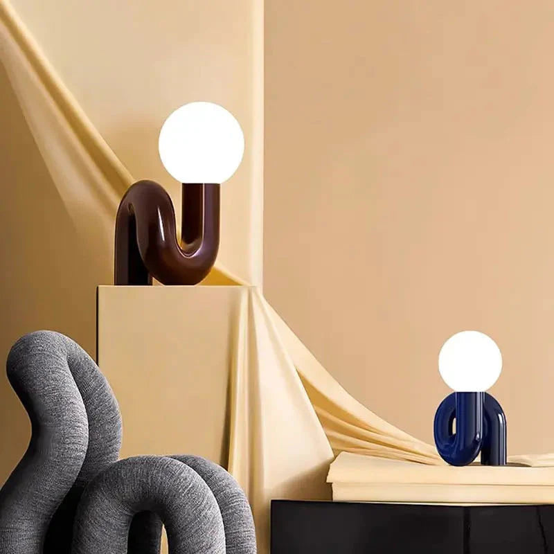 Neotenic table lamp casting a warm glow in a modern living room.