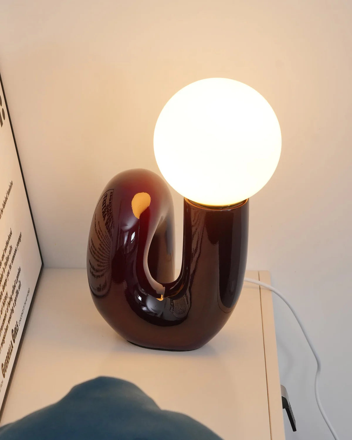 Sleek and elegant Neotenic table lamp on a minimalist office desk